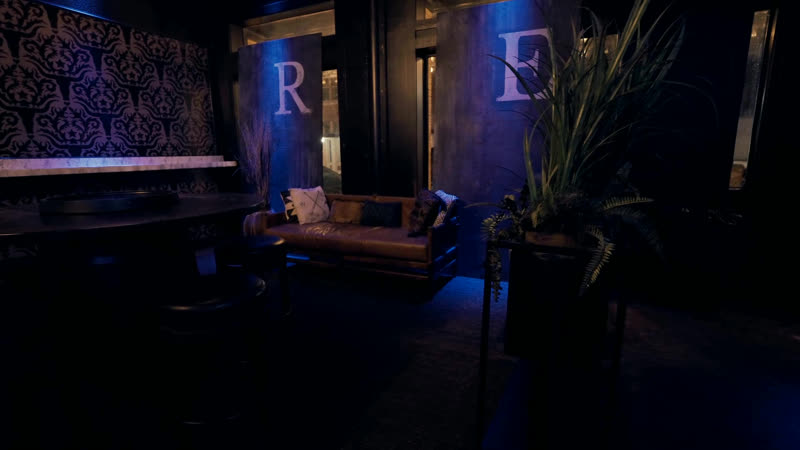 The VIP corner: leather banquette under the R and E monogram
